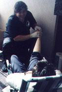 Mr Ian Guslin treats client with Reflexology